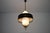 This italian pendant lamp from the 1960s is a refined example of mid-century lighting, combining brass, opal glass, and...