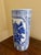 A classic blue and white porcelain umbrella stand in the chinoiserie tradition, featuring finely rendered birds among...