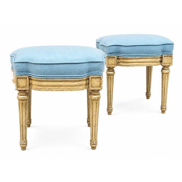 This is a pair of petite French Louis XVI style ottomans or stools. They have the original painted frames and tapered...