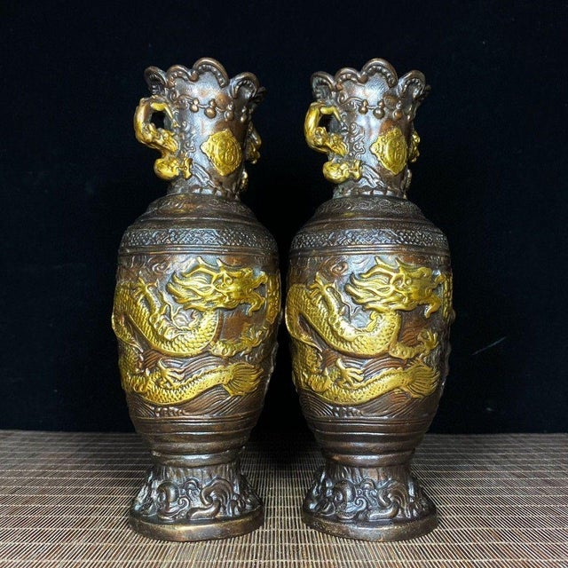 This is a striking pair of vintage Chinese gilt bronze vases, crafted from copper with high-relief decoration and gold...