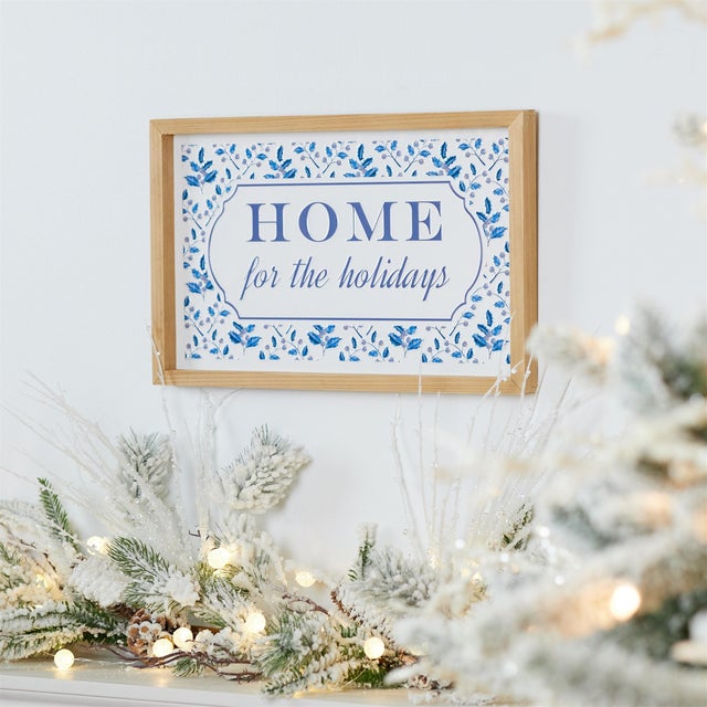 Invite the warmth of the season into your home with this "Home for the Holidays" wall sign. The sign features wintry white...