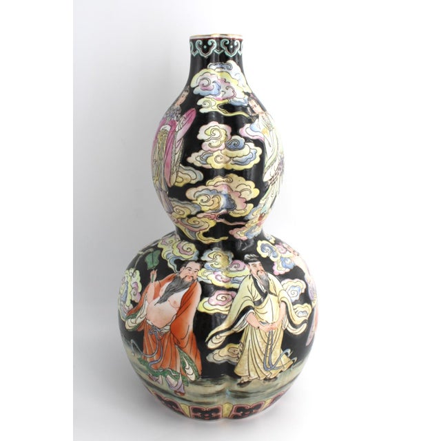 Antique Chinese Double-Gourd Porcelain Vase decorated in the Famille Noir palette with vibrant Fencai enamels. The body...