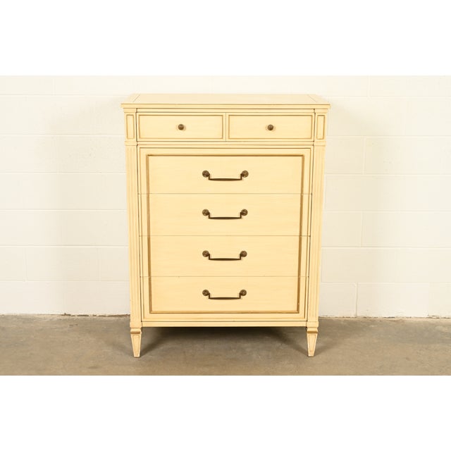 A gorgeous French Regency Louis XVI style highboy dresser By Henredon USA, Circa 1960s Carved cream lacquered walnut, with...