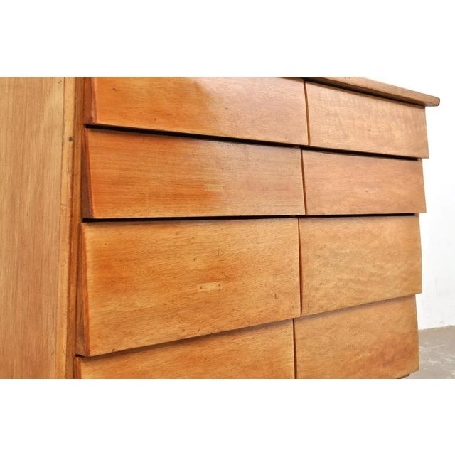 Beechwood chest of drawers with 8 drawers. 1950s. From a shop. The drawers have a slanted front and a practical handle on...