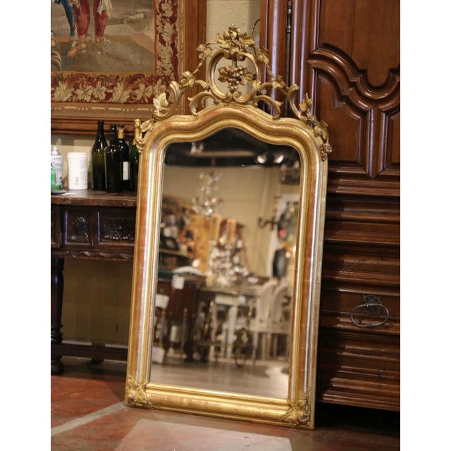 This elegant antique French mirror is distinguished by its richly carved grape and vine ornament, a particularly...
