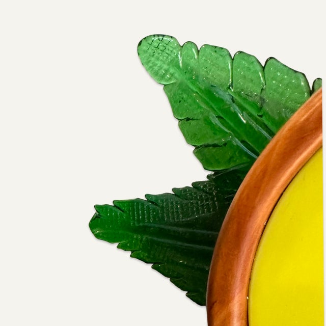 Ettore Sottsass (1917 - 2007,) creator of this circular postmodernist mirror featuring a lemon motif, was an Italian...