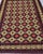 This hand-knotted Afghan Aqcha rug stops a room immediately. The deep burgundy field is organized in a bold star lattice —...