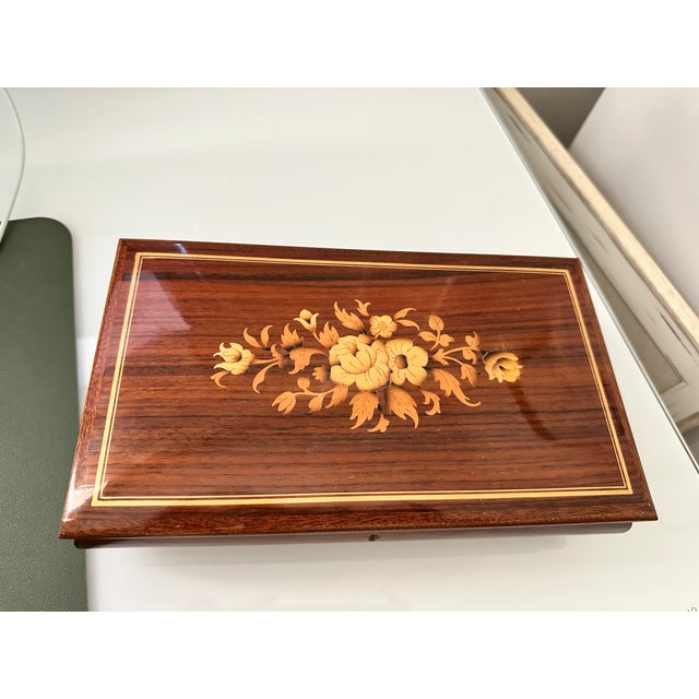 Beautiful large footed wooden box. Lid is beautifully inlaid with foliage floral decor. In excellent condition and no...
