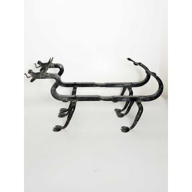 Striking pair of French cast iron andirons designed by Edouard Schenck in the 1950s. Each piece is conceived as a highly...