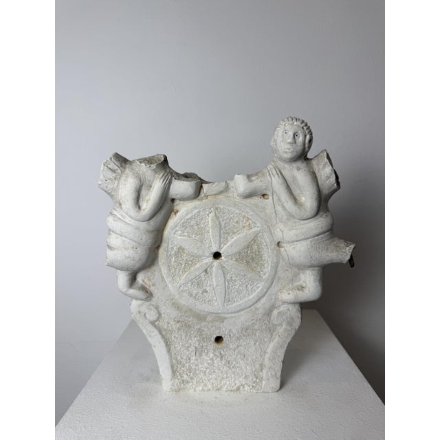 16th-century marble architectural fragment. Italy. This fragment features a central circle engraved with a six-petaled...