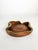 Sculptural ceramic ashtray with an organic freeform silhouette and warm terracotta-toned glaze, accented by an irregular...