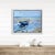 A solitary blue fishing boat rests peacefully on the sand as the tide slowly recedes across a quiet shoreline. Painted...
