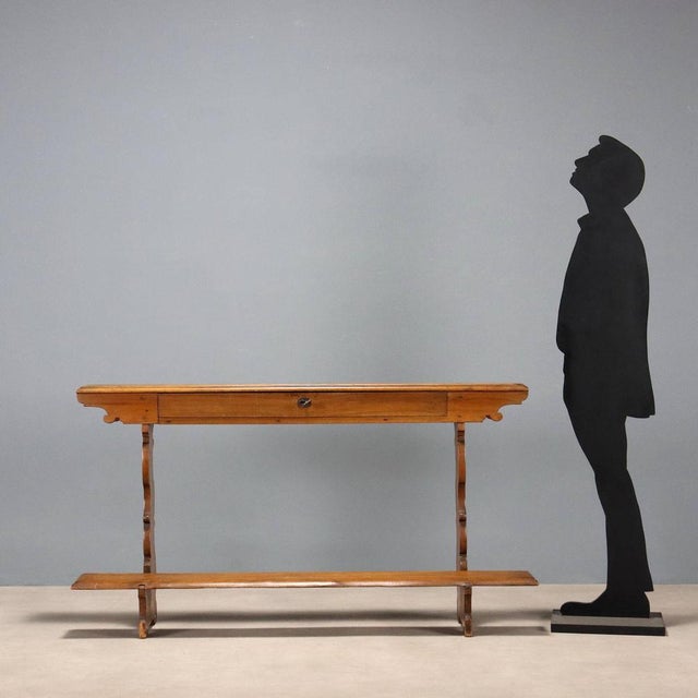 Walnut kneeler. Drawer in the lower section, curved scroll-worked uprights, brass initials 'F, P' applied to the top....