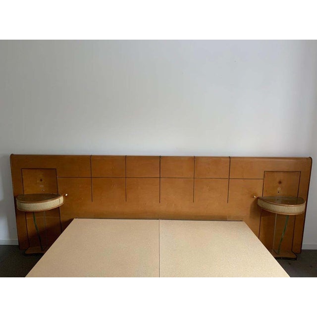 Art Deco bed with floating bedside tables, 1930s. Maple structure with rosewood parts. Headboard decorated with brass...