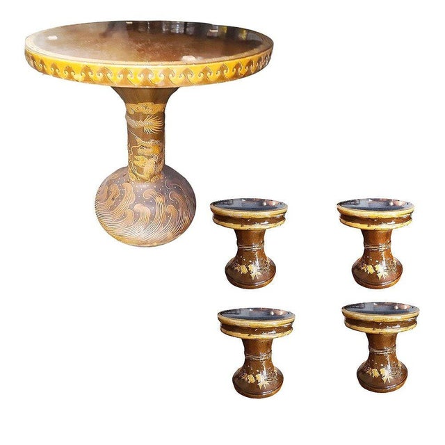 Original set of glazed art pottery garden furniture set featuring a pedestal dining table with a relief of chinese style...