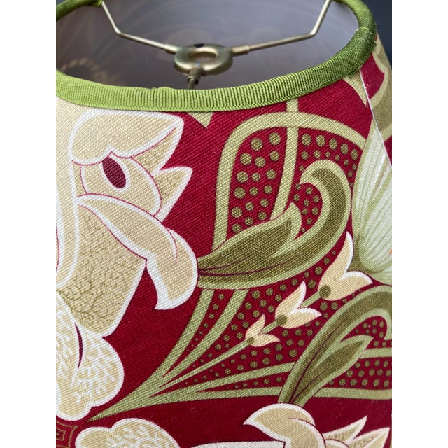 A lampshade made from a 19th century French printed cotton. Measurements: top 5” bottom 14” side8”