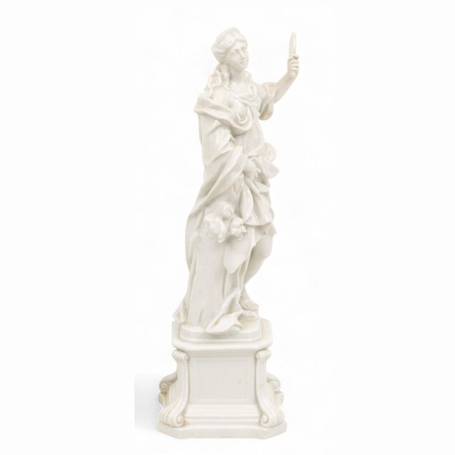 A refined 19th century Italian white porcelain sculpture by Capodimonte, depicting Prudence, one of the classical virtues....