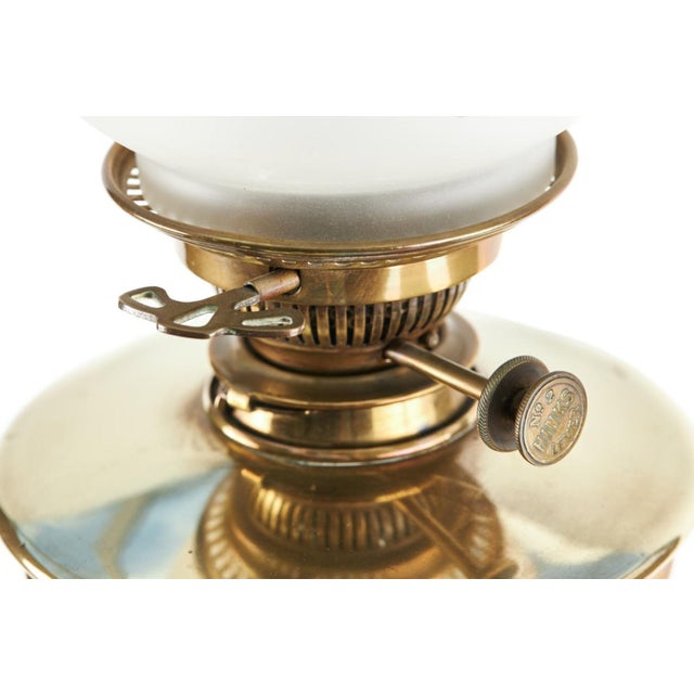 This is a quality 19th Century Victorian antique brass oil lamp with original glass shade and double brass burner font...