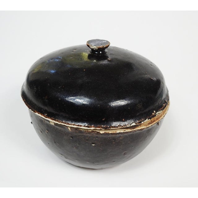 Mid 29th century primative brown glaze handmade pottery covered bowl. Unknown mark on botton. Scattered tiny edge nicks on...