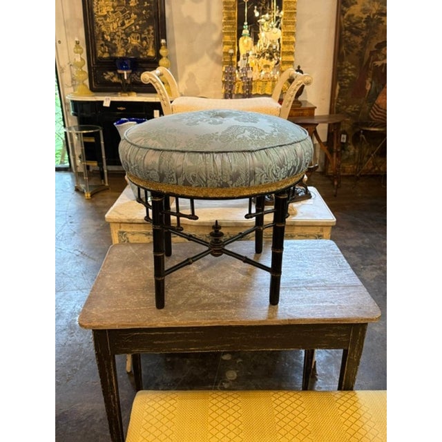The Late 19th c. English Regency Bamboo Form Stool is a rare and elegant piece of antique furniture. This stool features a...