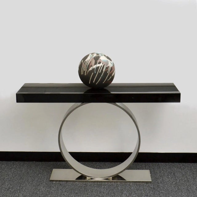 Ball shape sculpture hand sculpted in ceramic with drip glaze. The ball sits in its natural position by the distributed...