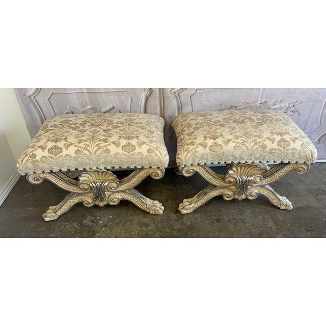 A magnificent and highly sculptural pair of Italian Venetian Baroque curule benches, embodying the drama and opulence of a...
