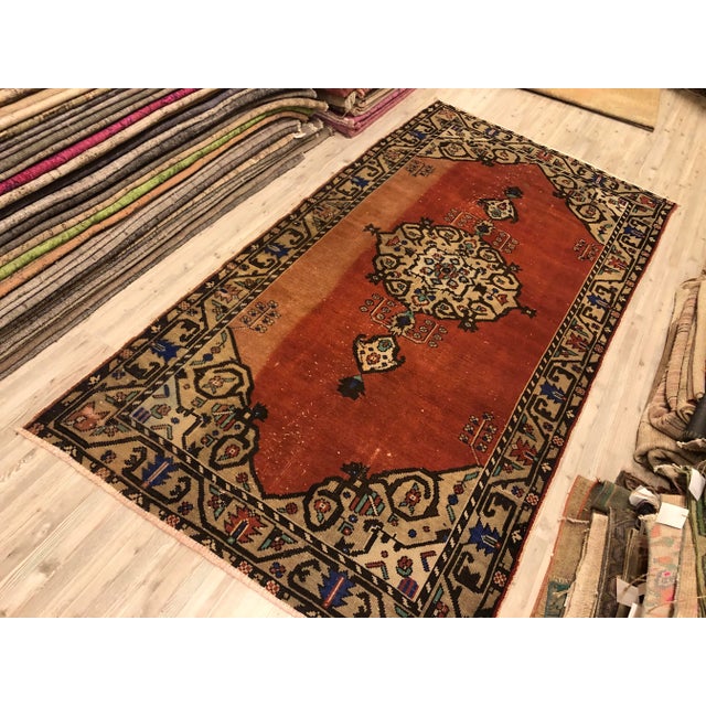 This is a vintage Turkish Oushak rug from the 1960s. The piece was hand-knotted.