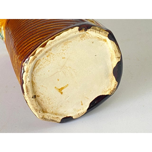 George Jones water lily pitcher. Designed with large green leaves, water lily flowers. The top neck with handle circa 1900.