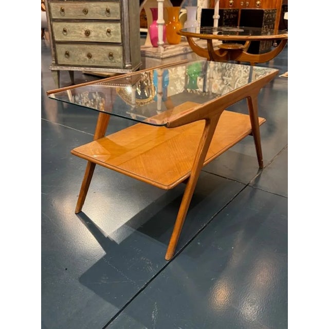 The Mid Century Modern Italian Walnut and Glass Coffee Table is a stylish piece of furniture. This interesting coffee...