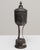 This 1937 Belgian silver-plated goblet presents an elegant, sculptural form elevated on three slender supports above a...