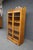 Victorian two-door oak bookcase featuring a pierced gallery crest, carved scroll detailing, and full-length glazed doors....