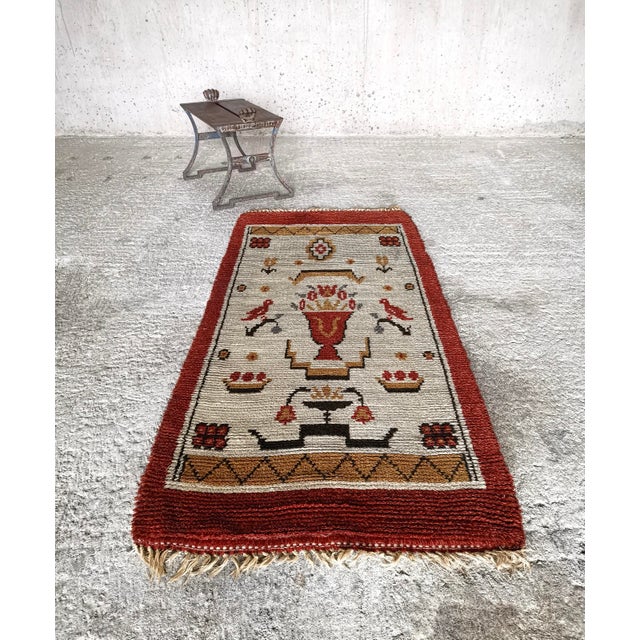 An exceptional and highly decorative Swedish Grace rya rug from the 1920s, showcasing a vivid and finely balanced...
