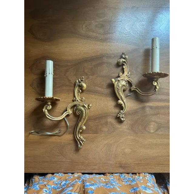 Highly detailed with traditional motifs; a swag support holding one ornate candle holder; solid brass with significant...