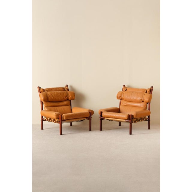 A pair of the very comfortable Inca chair in patinated brown original buffalo leather. Designed by Arne Norell, produced...