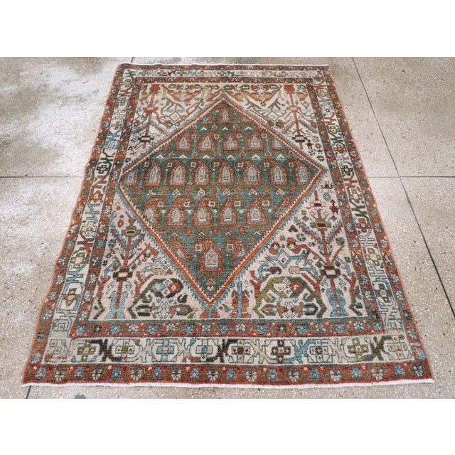 This mid-20th-century Persian Malayer accent rug presents a bold geometric composition centered on a large diamond-shaped...