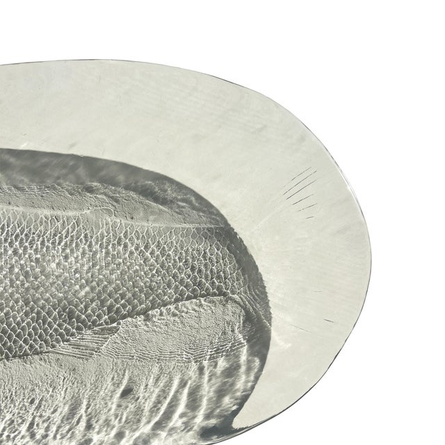 This striking French art glass platter features a finely modeled fish rendered in high-relief beneath a thick, softly...