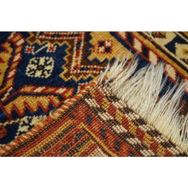 The closely stepped and layered diamond-shaped ecru medallion displays the definitive "Qashghai gul" on a pointed and side...