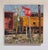 The artwork depicts a vibrant, textured scene featuring a weathered stop sign at a railroad crossing, juxtaposed against...