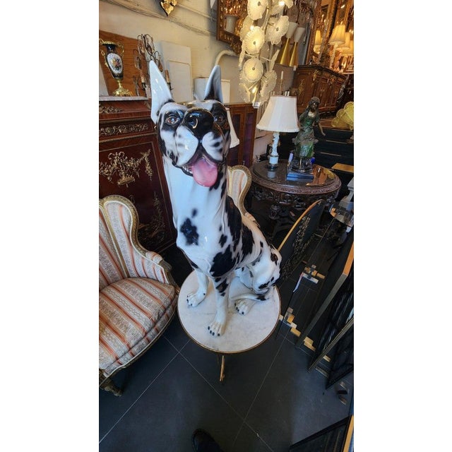 A life-size ceramic Harlequin Great Dane, hand painted from Italy that was most likely produced around 1970-1979....
