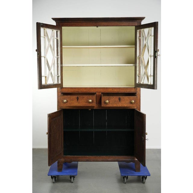 This beautiful antique 18th-century English oak bookcase/sideboard, featuring exquisite original glass, is in good...