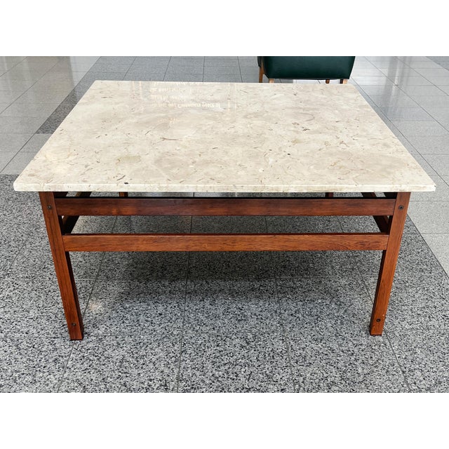 This classic Mid-20th Century square coffee table consists of a travertine top and a rosewood base. The design is...