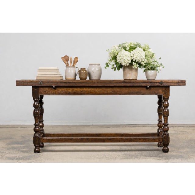 This antique French oak folding table was sourced in the French Alps and dates to the early 19th century. Crafted from...