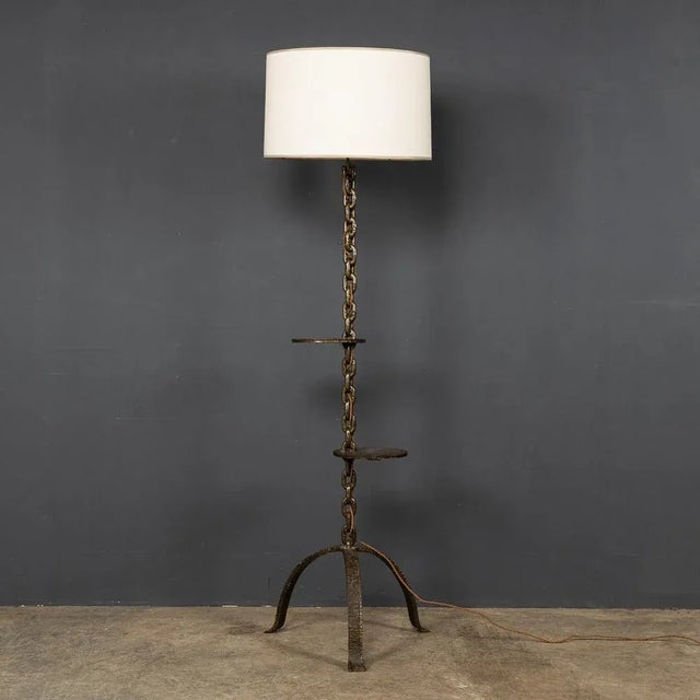 An elegant and unusual freestanding lamp with 2 integrated shelves in the stand, made in France around the 1930's. The...