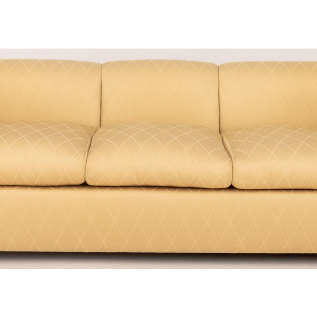 Modern Golden Silk Blend Upholstered Three-Seat Sofa, with scrolled ends. 28" H x 84" W x 36" D; seat: 18" H. Provenance:...
