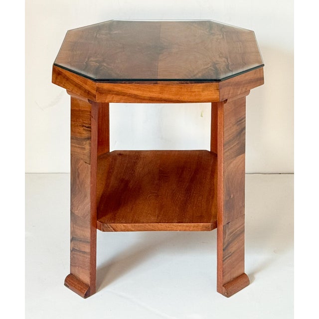 A fine English side table or occasional table from the Art Deco period, featuring an octagonal table top over a low shelf...