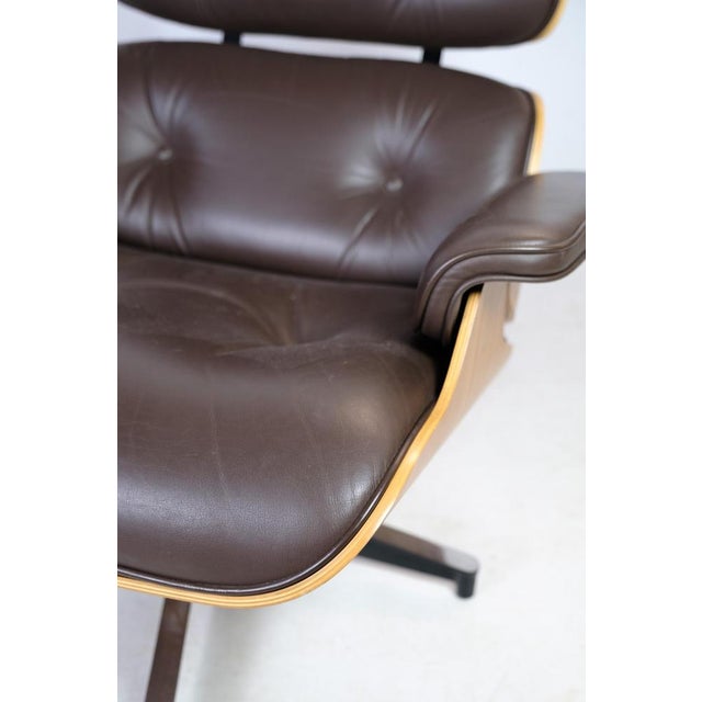 Charles eames lounge chair in brown leather and light walnut produced by herman miller designed in 1958 and produced in...