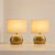 Elegant pair of Italian table lamps from the 1970s, crafted in cast brass and completed with oval fabric shades. Each lamp...