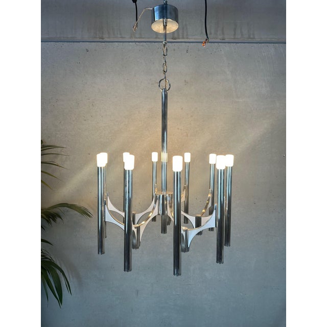 Large vintage designer chandelier by sciolari. 10x e14 light points on chrome tubes. Marked. Electrical wiring has been...