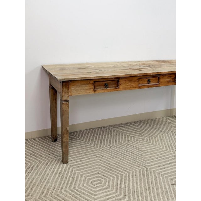 This substantial vintage Nadeau Indonesian solid wood console table is a beautifully crafted and characterful entryway or...