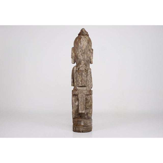 Hampatong-style sculpture from the Dayak people, carved in ironwood. Grayish patina with possible traces of kaolin, likely...